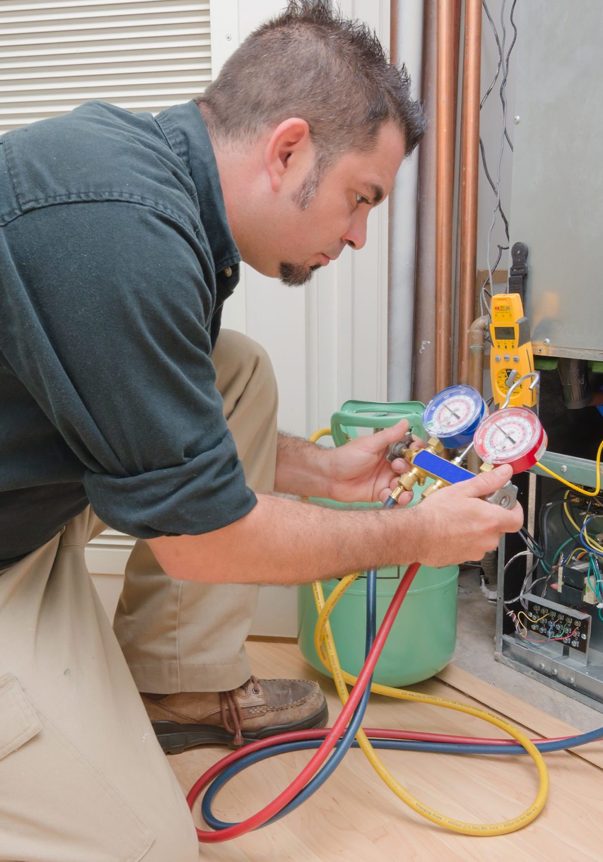 Hvac Technician Working HVAC technician charging a heat pump with refrigerant